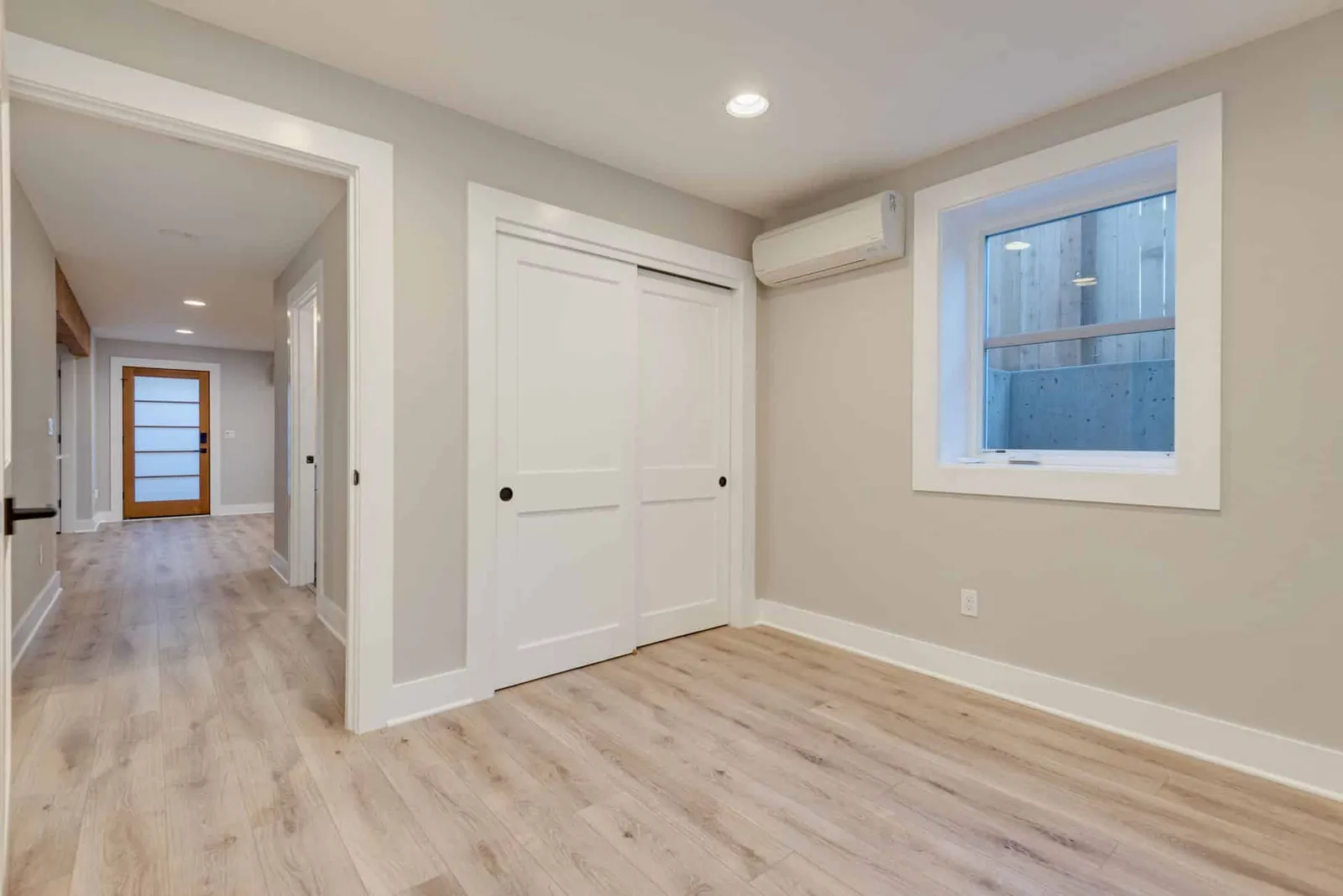 Finished basement bedroom with a code-size egress window and a window well outside