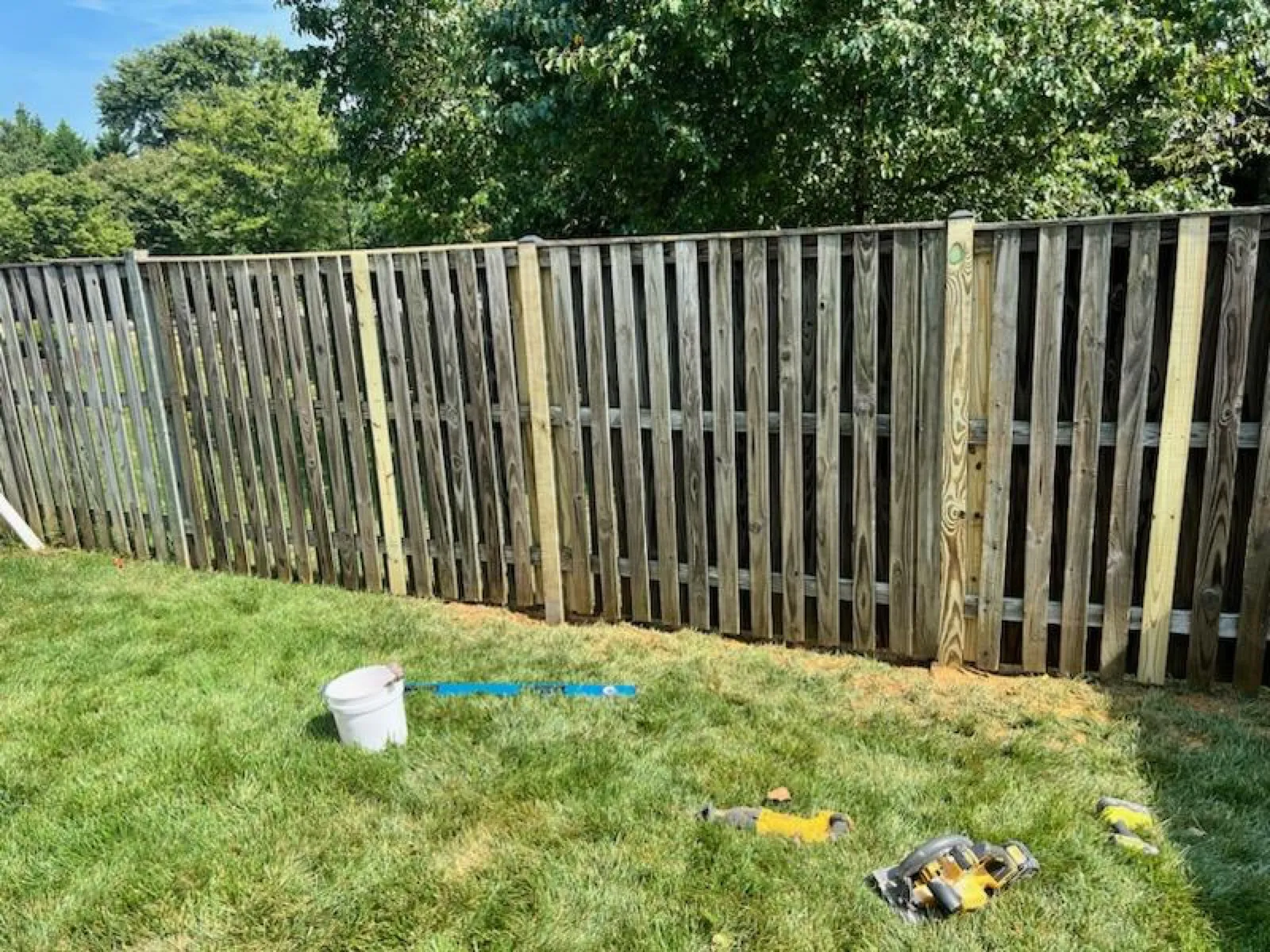 New fence pickets replacing a weathered section